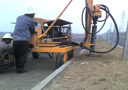 Steel highway guardrail post installation